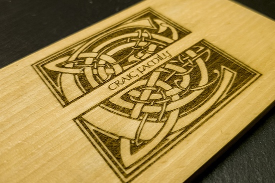 A closeup view: Small Cutting/cheese or serving board with monogram and family name engraved